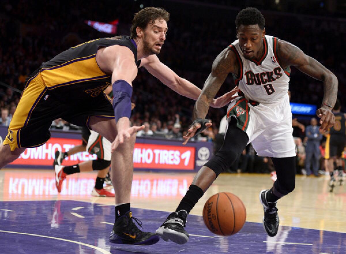 Lakers center Pau Gasol, left, and Milwaukee's Larry Sanders chase after a loose ball during the Lakers' loss on Tuesday. Injuries and defensive struggles have played a dominant role in the Lakers' six-game losing streak.