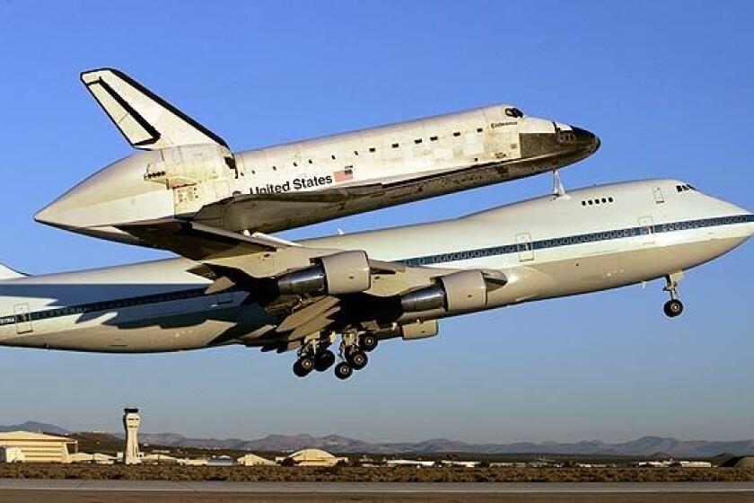 The space shuttle Endeavour takes off from Edwards Air Force Base piggybacked to a modified 747 on its way back to the Kennedy Space Center in Florida.