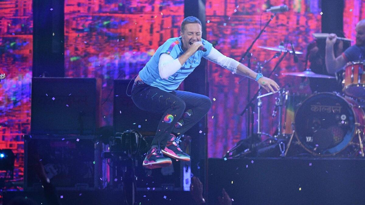 Chris Martin of Coldplay performs with the Chainsmokers during Wednesday's Brit Awards in London.