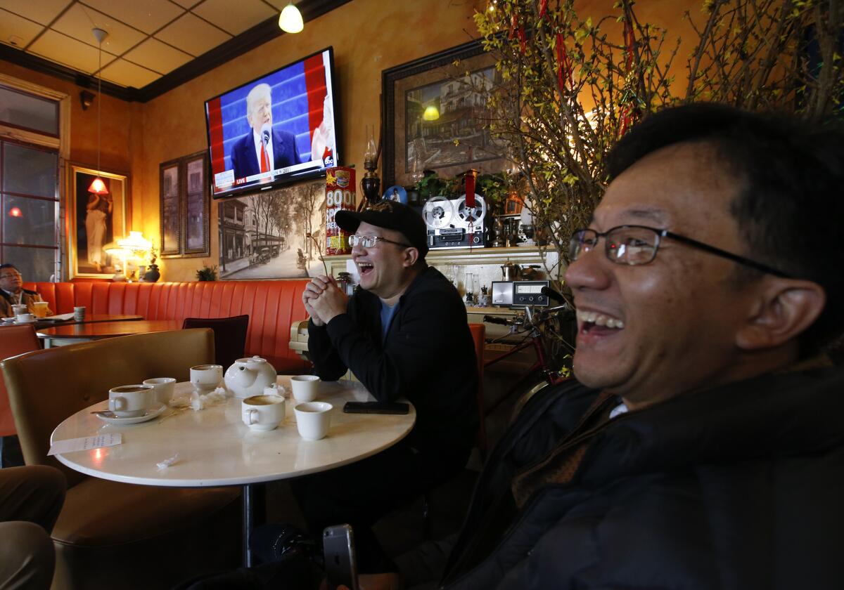 Customers watch the inauguration at the Gypsy Den in Little Saigon.