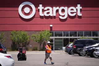 FILE - A worker collects shopping carts in the parking lot of a Target store on June 9, 2021, in Highlands Ranch, Colo. Target is removing certain items from its stores and making other changes to its LGBTQ merchandise nationwide ahead of Pride month, after an intense backlash from some customers including violent confrontations with its workers. (AP Photo/David Zalubowski, File)