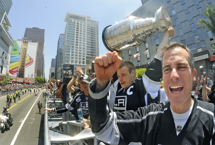 Los Angeles Mayor Eric Garcetti, right, cheers as Kings captain Dustin Brown hoists the Stanley Cup during the team's victory parade June 16 in downtown L.A.