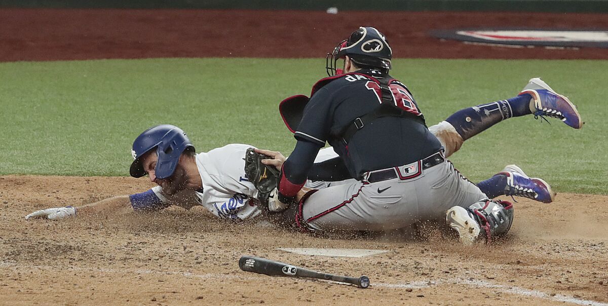 Dodgers baserunner Chris Taylor is tagged out by at home Atlanta Braves catcher Travis d'Arnaud during the sixth inning.