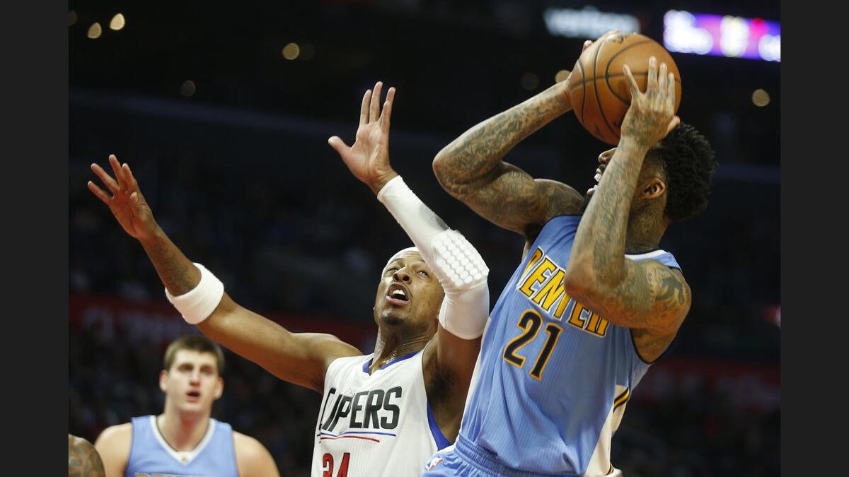 Clippers forward Paul Pierce guards Denver Nuggets forward Wilson Chandler during the Clippers' 119-102 win at the Staples Center on Tuesday. Pierce started the game in the absence of Blake Griffin, who is recovering from knee surgery.