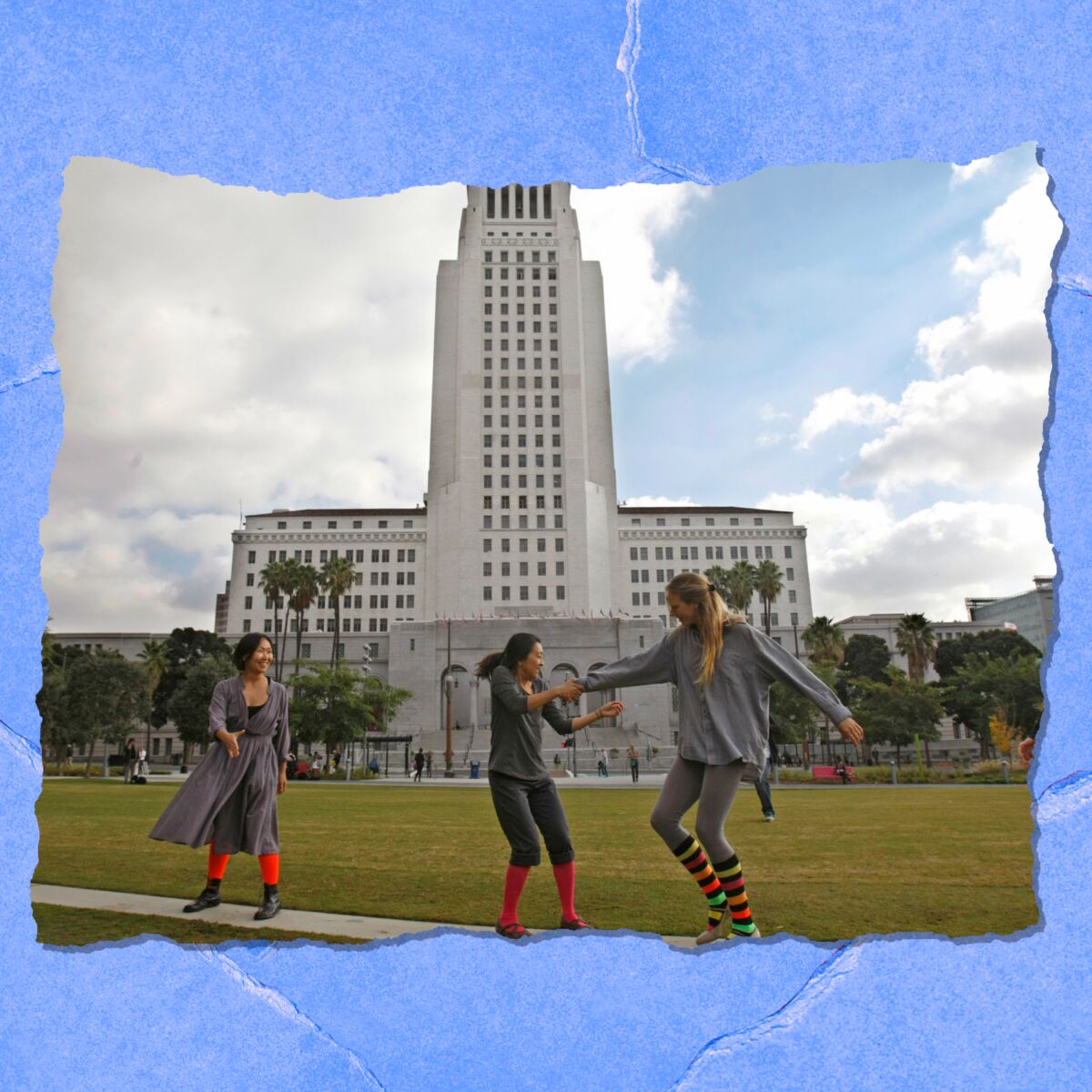 People in bright knee socks interact in front of a large building.
