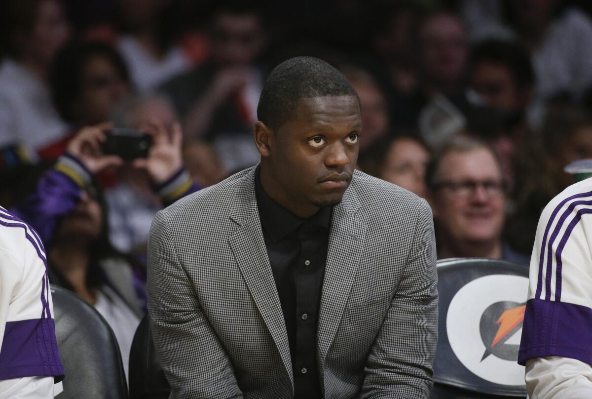 Injured Lakers rookie forward Julius Randle watches from the bench during a Lakers' loss to the Jazz earlier this month.