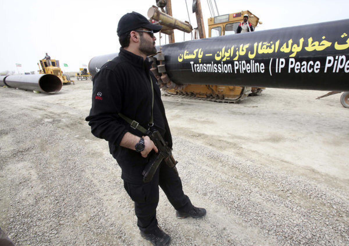 An Iranian security officer in Chabahar stands guard near the construction of a natural gas pipeline between Iran and Pakistan.