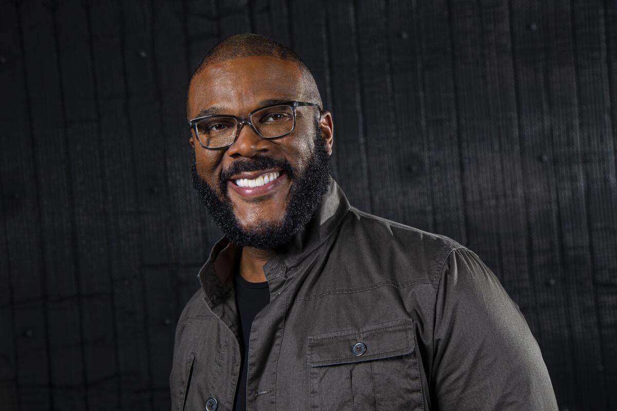 Portrait of Tyler Perry against a charcoal background.