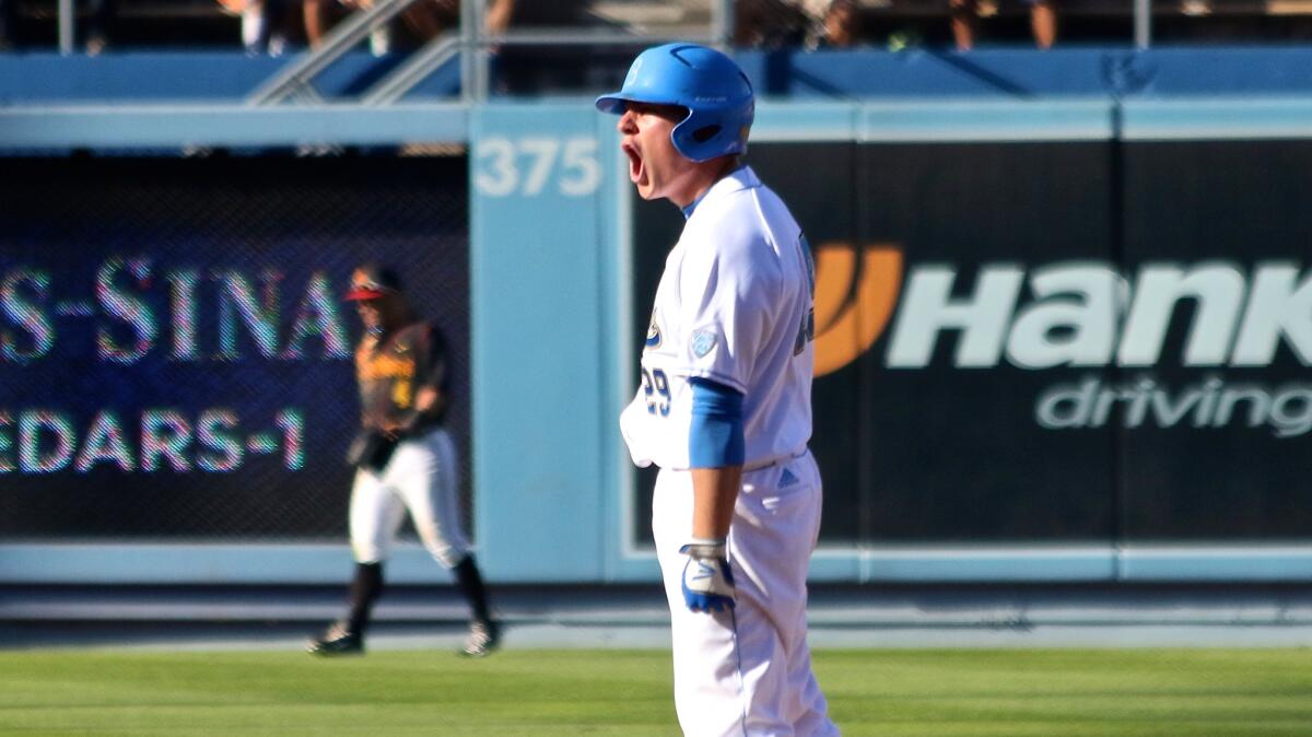 UCLA outfielder Ty Moore celebrates a run-scoring double against USC during the Dodger Stadium College Baseball Classic.