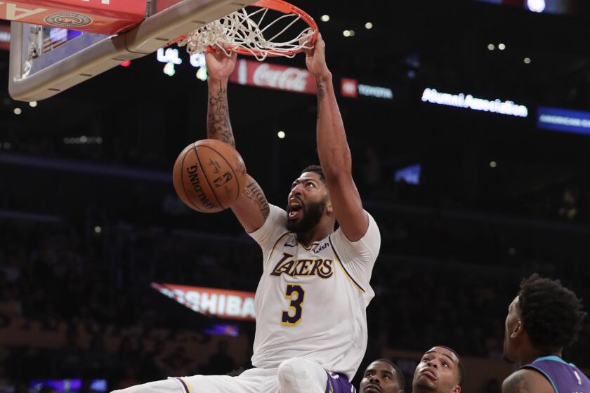LOS ANGELES, CA, SUNDAY, OCTOBER 27, 2019 - Los Angeles Lakers forward Anthony Davis (3) slams the ball home over Charlotte Hornets forward Miles Bridges (0) during second quarter action at Staples Center.(Robert Gauthier/Los Angeles Times)