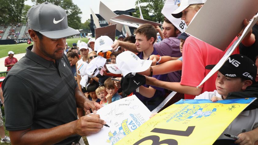 Tony Finau signs his autograph for a fan during a practice round prior to the 2018 PGA Championship at Bellerive Country Club on Wednesday in St. Louis.