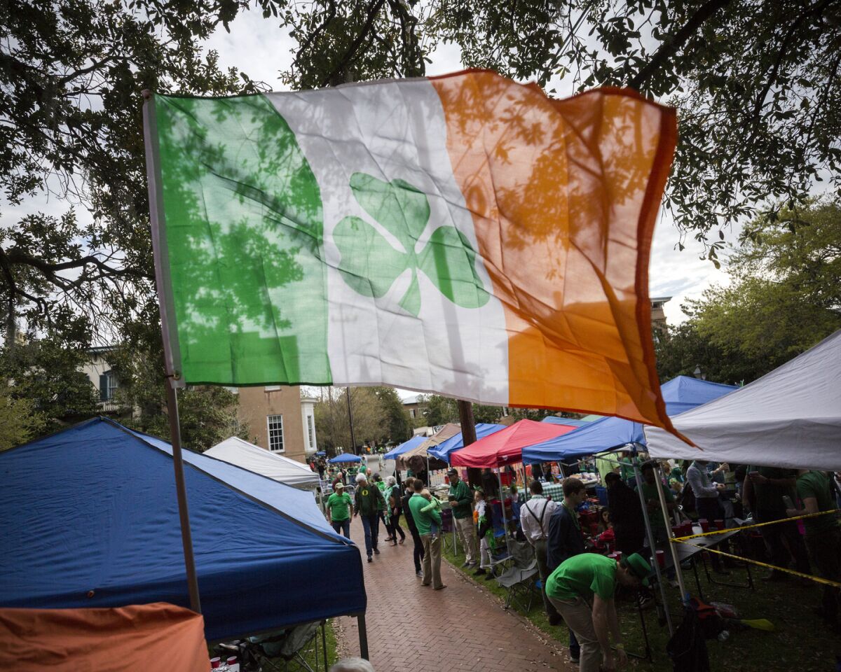 FILE - Revelers prepare for the 195-year-old St. Patrick's Day parade on one of the city's historic squares, Saturday, March 16, 2019, in Savannah, Ga. Savannah is gearing up for a big comeback of its most profitable holiday Thursday, March 17, 2022, as its beloved St. Patrick's Day parade returns for the first time since 2019. .(AP Photo/Stephen B. Morton, File)