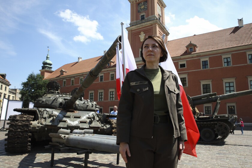 Deputy Minister of Defense of Ukraine, Hanna Maliar, poses for a picture during an opening of an open-air exhibition of damaged and burnt-out Russian tanks and armored vehicles at the Castle Square, in Warsaw, Poland, Monday, June 27, 2022. The vehicles were captured by Ukrainian military forces during the war in the Ukraine. Ukrainian authorities announced that there are plans for similar exhibits in other European capitals such as Berlin, Paris, Madrid and Lisbon. (AP Photo/Michal Dyjuk)