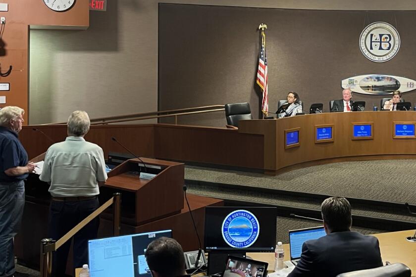 City Council members Rhonda Bolton, Mike Posey and Mayor Barbara Delgleize listen to Mackey Davis, left, speak against proposed development during Tuesday's Council meeting.