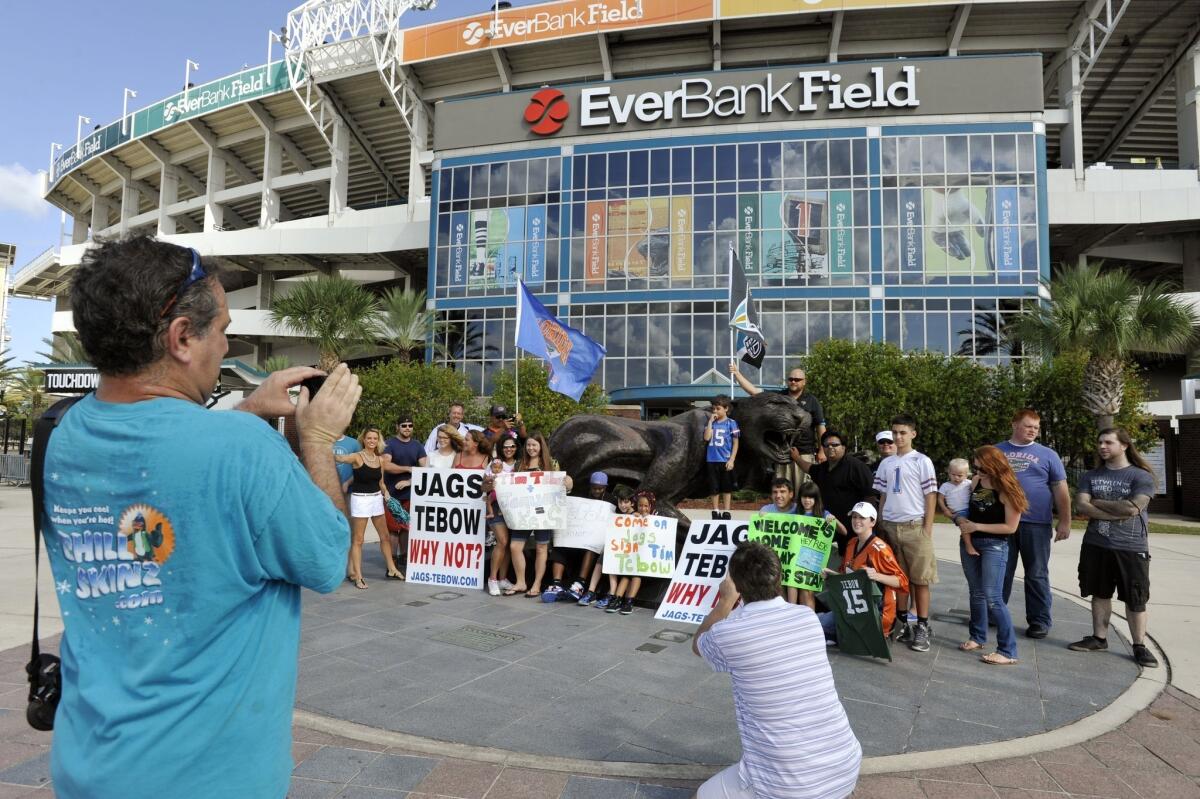 Jon Durst, left, takes a group photo of fans during a rally Monday at EverBank Field to encourage the Jacksonville Jaguars to sign Tim Tebow.