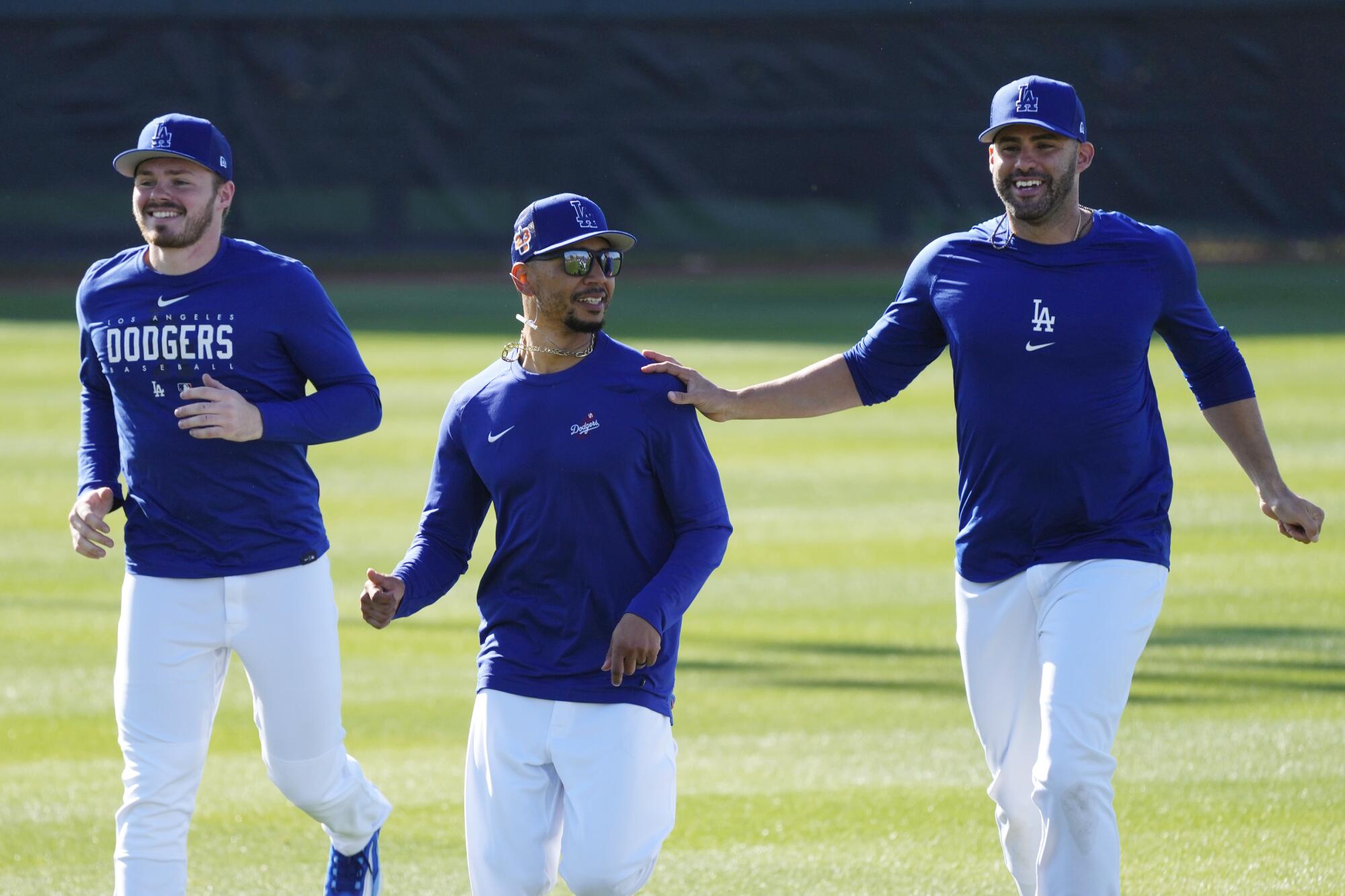 The Dodgers' Gavin Lux, Mookie Betts and J.D. Martinez run during a spring training workout in Phoenix 