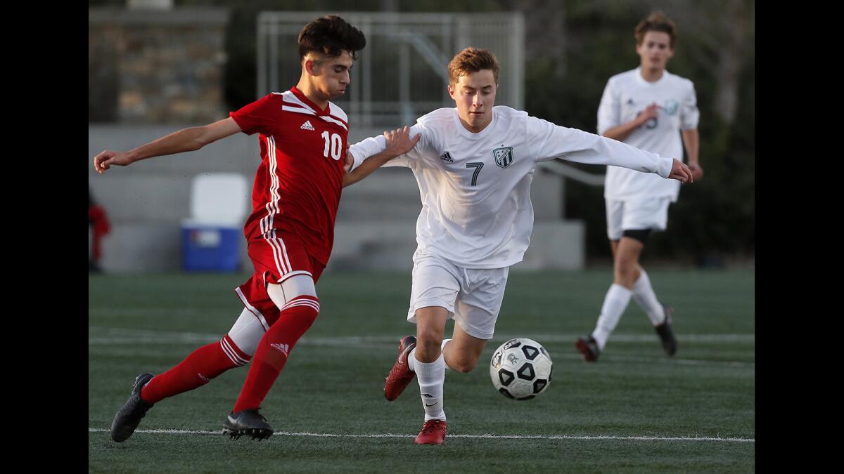 Edison High's Armand Pigeon (7) battles against Santa Ana's Cesar Zamora (10) during the first half in the Hawks Invitational at Lake Forest Sports Park on Dec. 26, 2018.