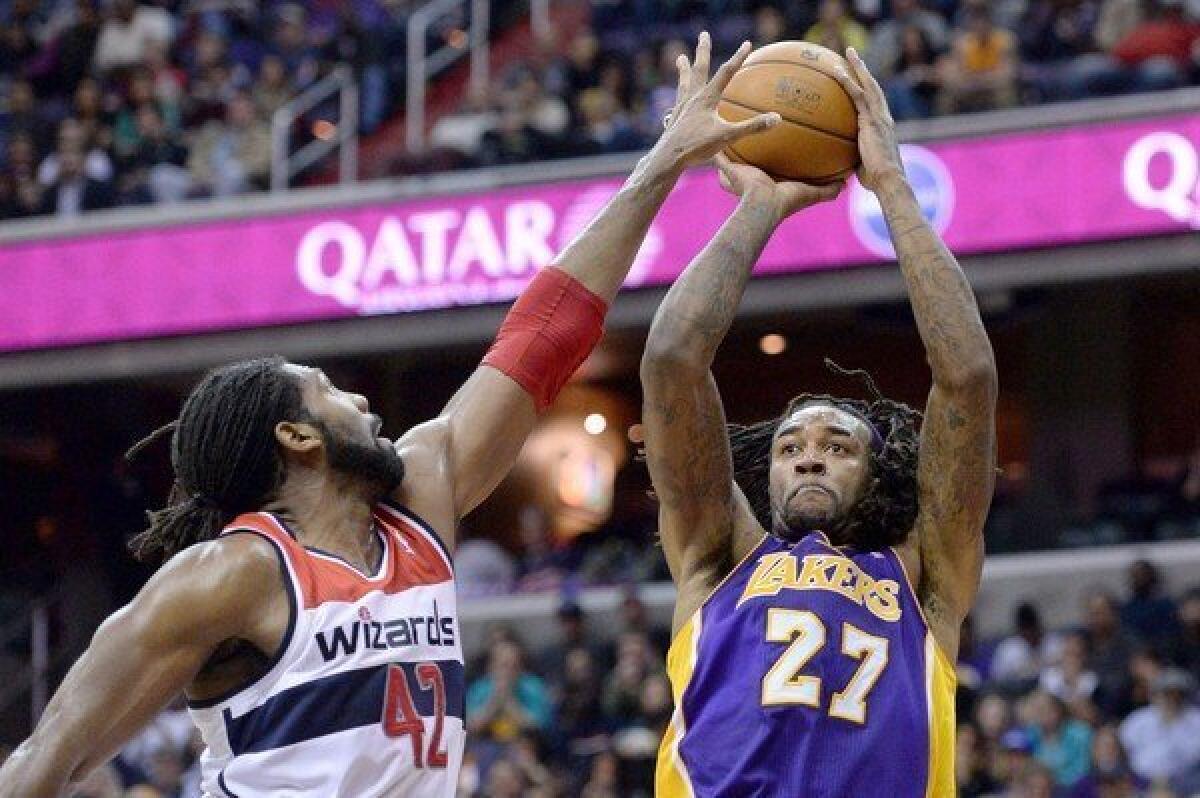 Jordan Hill shoots over Washington power forward Nene Hilario during the Lakers' 116-111 loss to the Wizards at the Verizon Center in Washington, D.C. on Tuesday.