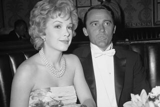 FILE - Actress Stella Stevens and actor Robert Vaughn, a nominee for best supporting actor of the year for "The Young Philadelphians," arrive at the Academy Award fashion show which preceded the Oscar presentations in Hollywood, April 4, 1960. Stevens, a prominent leading lady in 1960s and '70s comedies who is perhaps best known for playing the object of Jerry Lewis’s affection in “The Nutty Professor,” died Friday. She was 84. (AP Photo, File)
