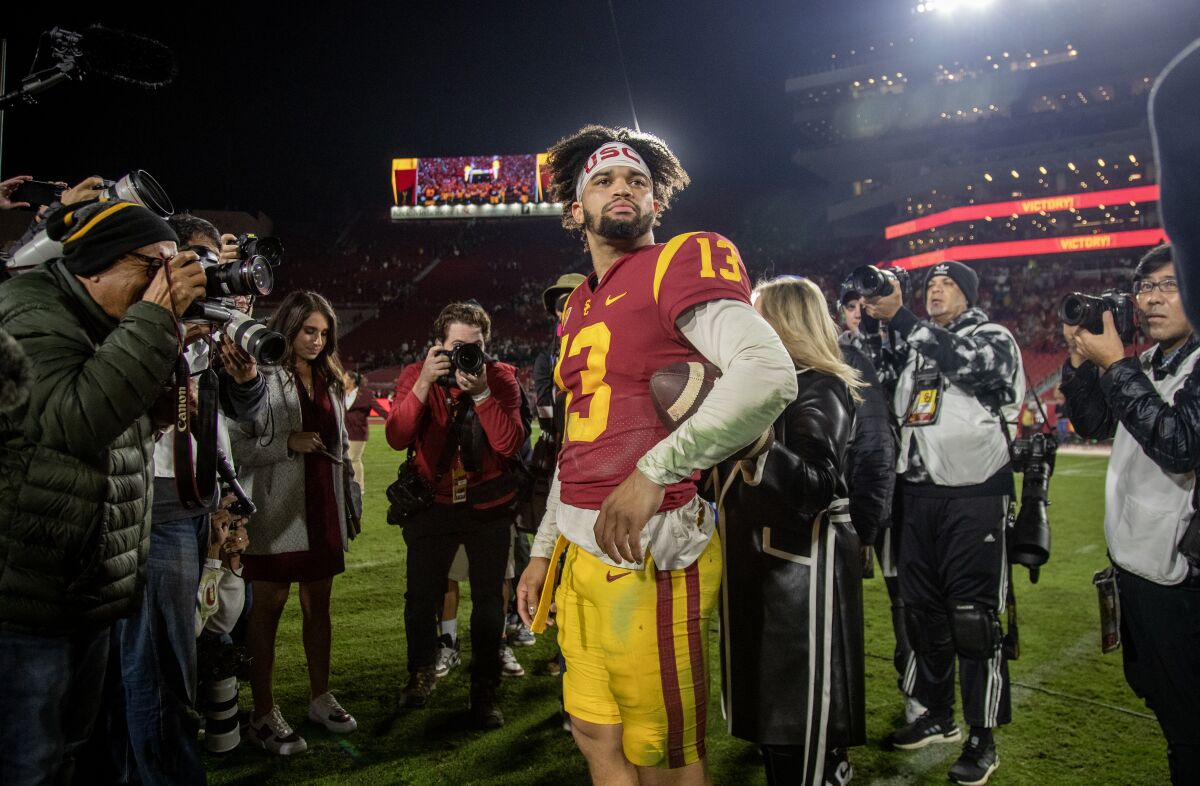 Trojans quarterback Caleb Williams is surrounded by reporters after USC's win over Notre Dame on Nov. 26, 2022.
