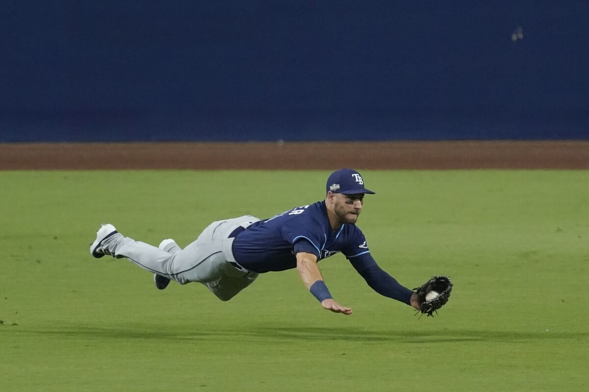 Tampa Bay Rays center fielder Kevin Kiermaier makes a leaping catch on a fly ball by Houston Astros Carlos Correa during the third inning in Game 3 of a baseball American League Championship Series, Tuesday, Oct. 13, 2020, in San Diego. (AP Photo/Ashley Landis)