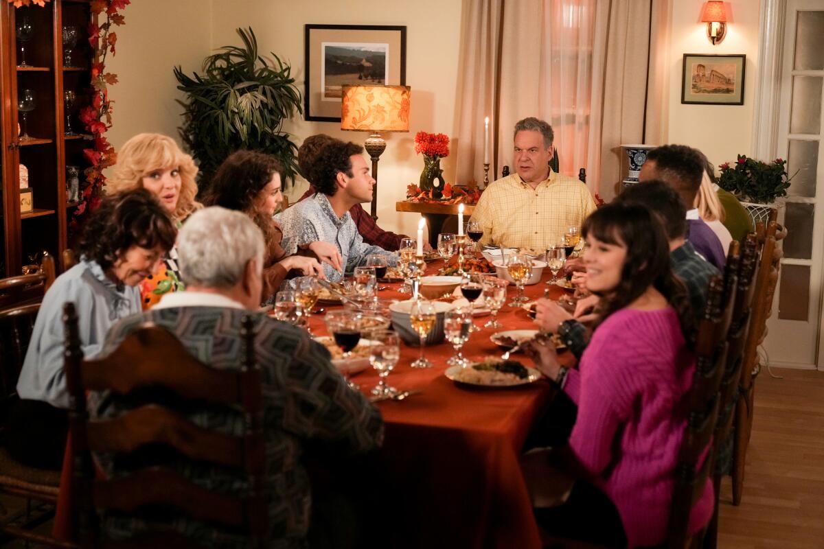 A family sits around a table for a meal.