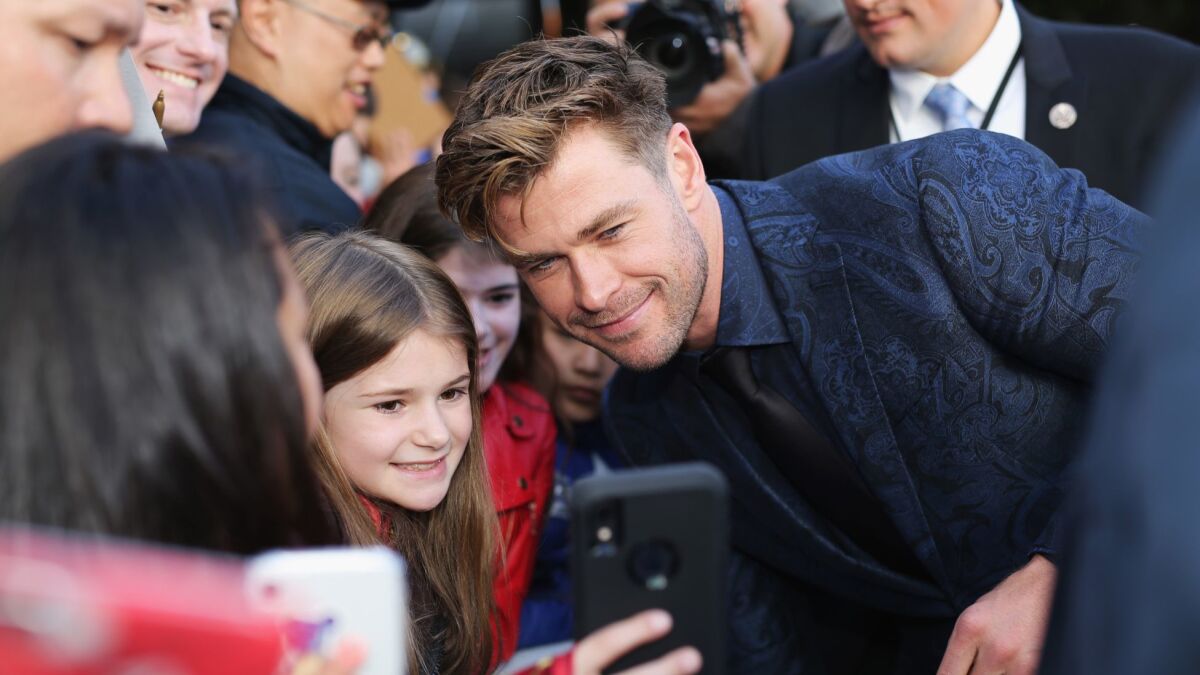 Chris Hemsworth takes a photo with a fan at the world premiere of Marvel Studios' "Avengers: Endgame" at the Los Angeles Convention Center on Monday.