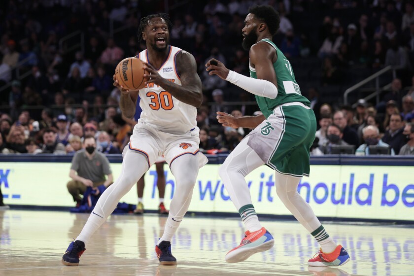New York Knicks forward Julius Randle (30) looks to pass the ball around Boston Celtics guard Jaylen Brown during the first half of an NBA basketball game Thursday, Jan. 6, 2022, in New York. (AP Photo/Adam Hunger)