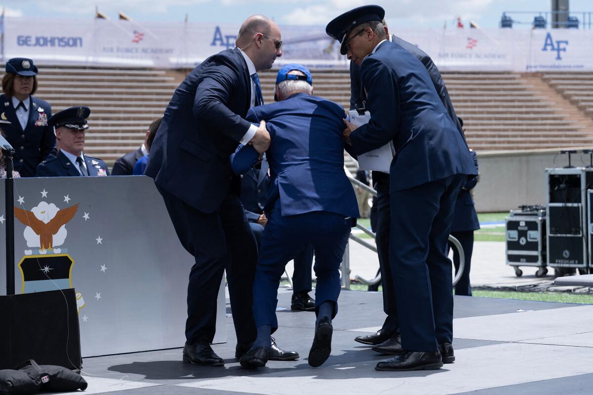 President Biden is helped up after tripping on a sandbag during the graduation ceremony at the U.S. Air Force Academy.