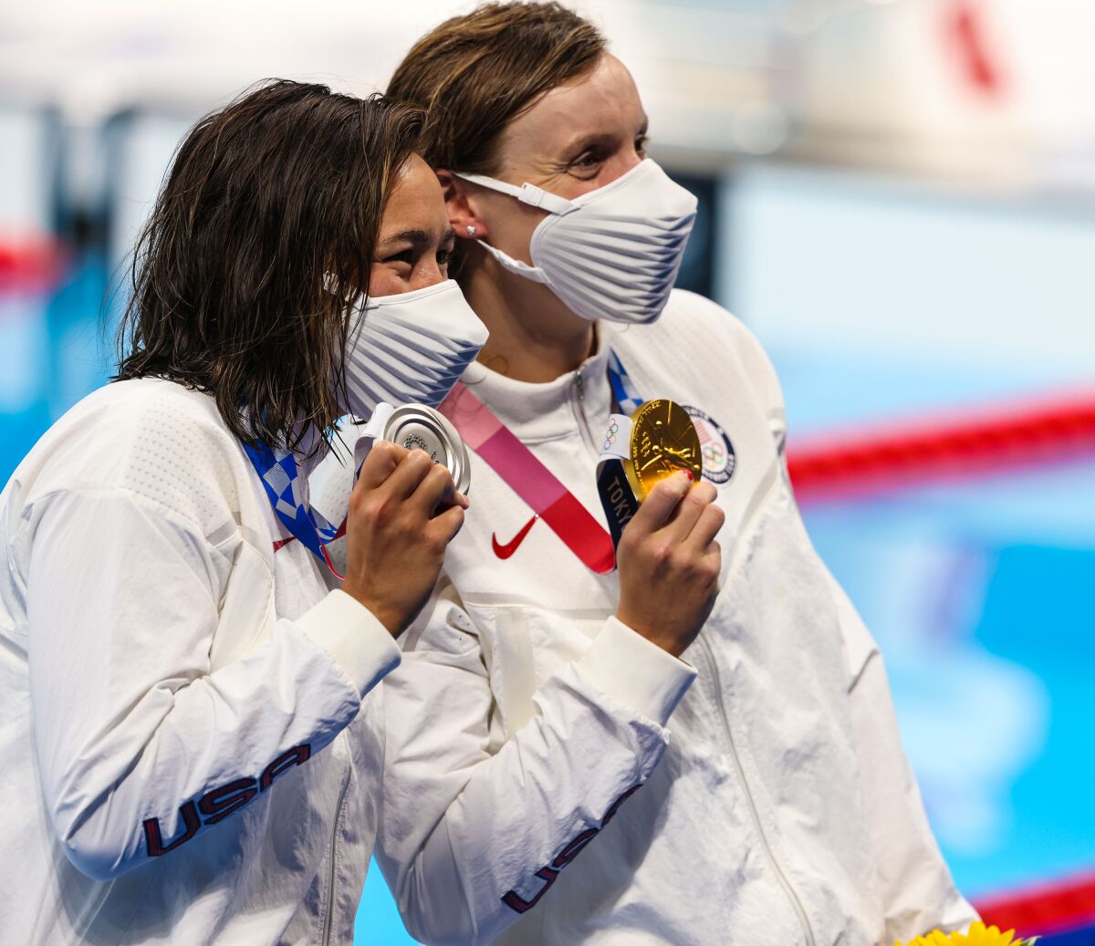 Katie Ledecky and Erica Sullivan show off their gold and silver medals.