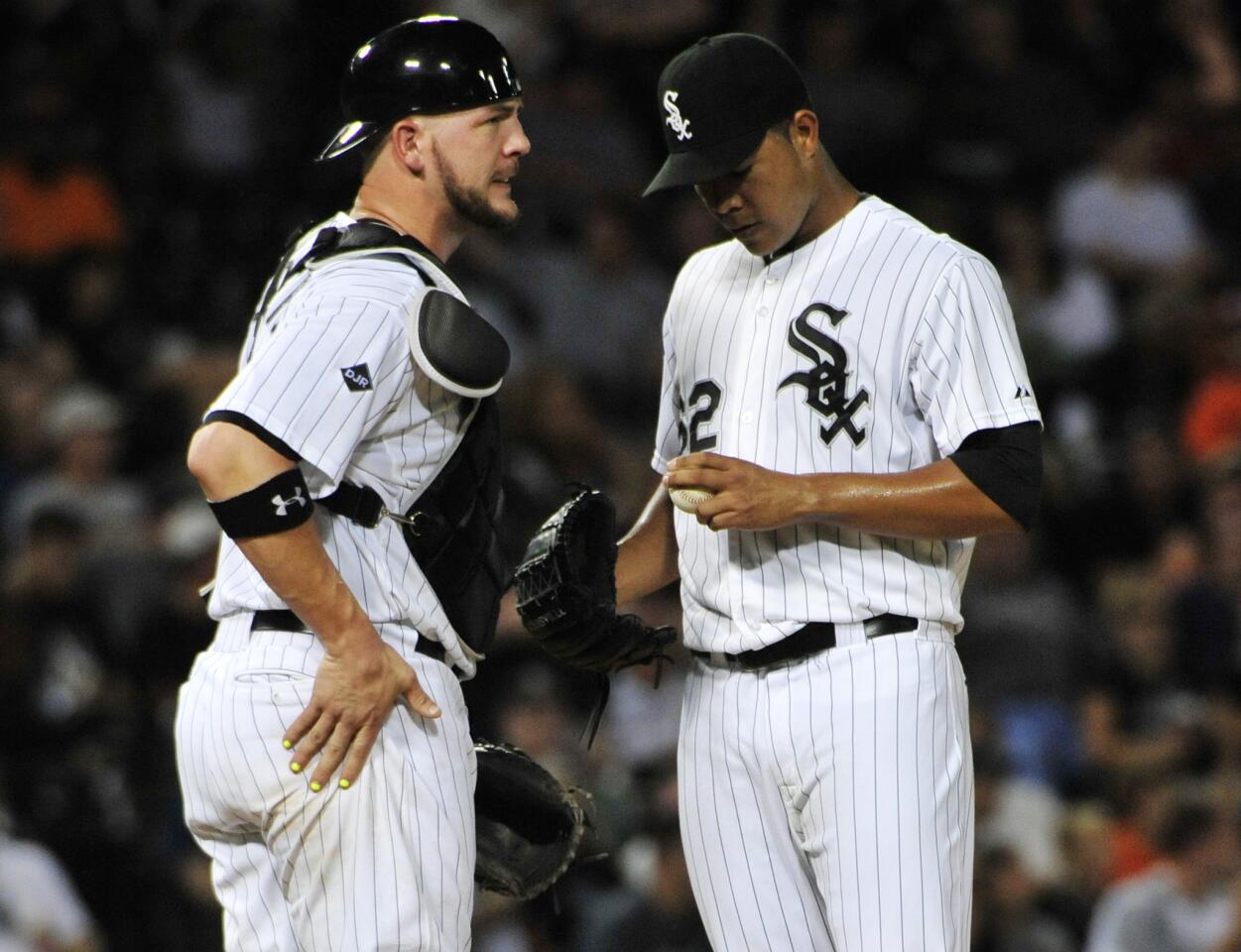 White Sox starter Jose Quintana talks with Tyler Flowers during the sixth inning.