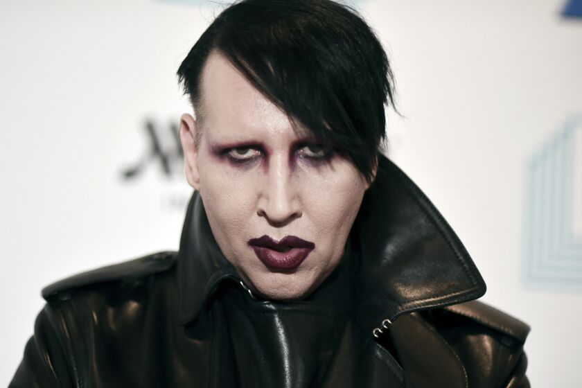 FILE - Marilyn Manson attends the 9th annual "Home for the Holidays" benefit concert in Los Angeles, on Dec. 10, 2019. Authorities searched the home of the rocker on Monday, Nov. 29, 2021, after allegations of physical and sexual abuse by several women. (Photo by Richard Shotwell/Invision/AP, File)