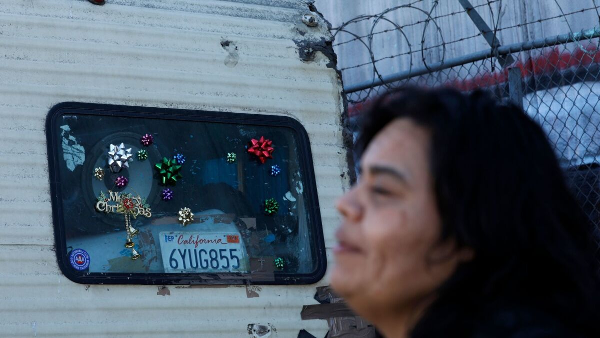 Aileen Kemper stands beside the Boyle Heights RV she shared with her mother, who was struck and killed by a hit-and-run driver on Union Pacific Avenue.