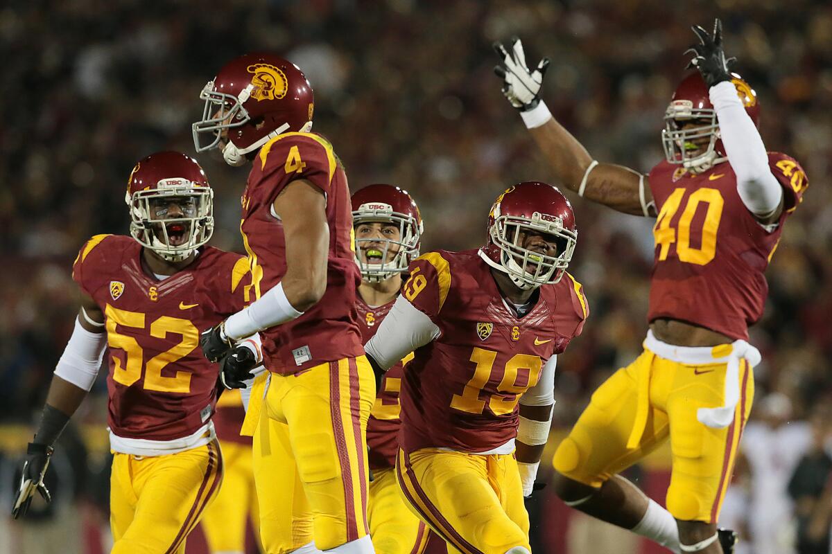 USC defenders -- including Quinton Powell (52), Torin Harris (4), Michael Hutchings (19) and Jabari Ruffin (40) -- celebrate after stopping the Stanford offense on Nov. 16, 2013.