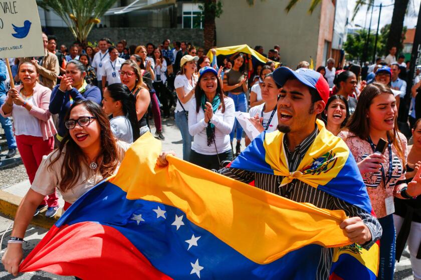 Venezuelan opposition protesters participate in a demonstration to demand the end of the crisis and in support of the interim presidency of Juan Guaido, in Caracas.
