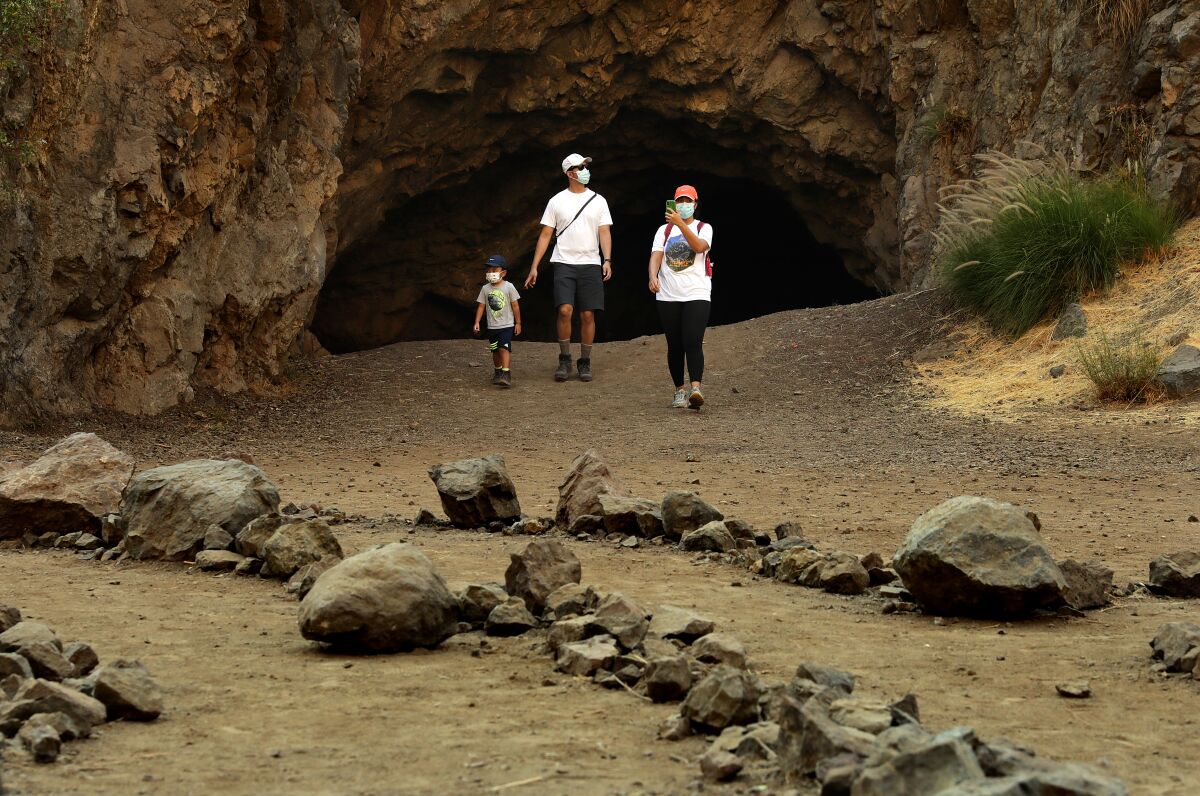 A family walks out of Bronson Cave