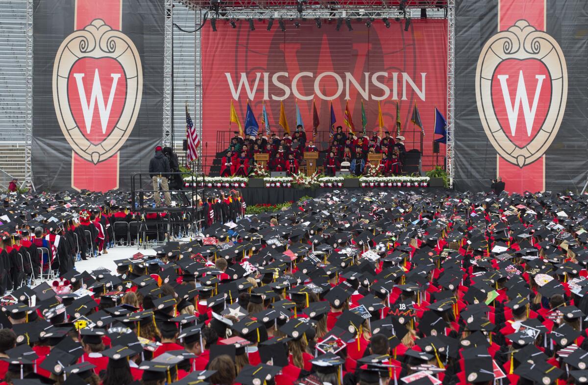 Audience members listen to the commencement address at the University of Wisconsin in Madison on May 12, 2018.