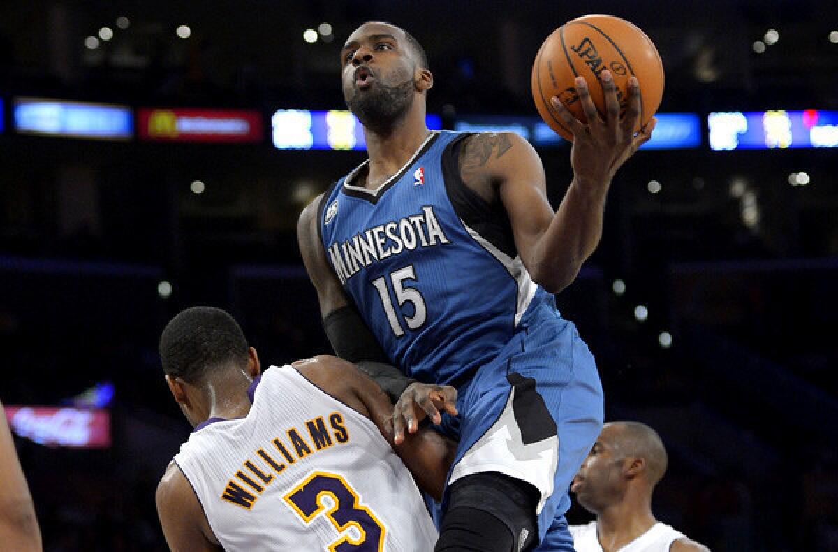 Timberwolves forward Shabazz Muhammad (15) elevates over Lakers forward Shawne Williams during a game earlier this season.