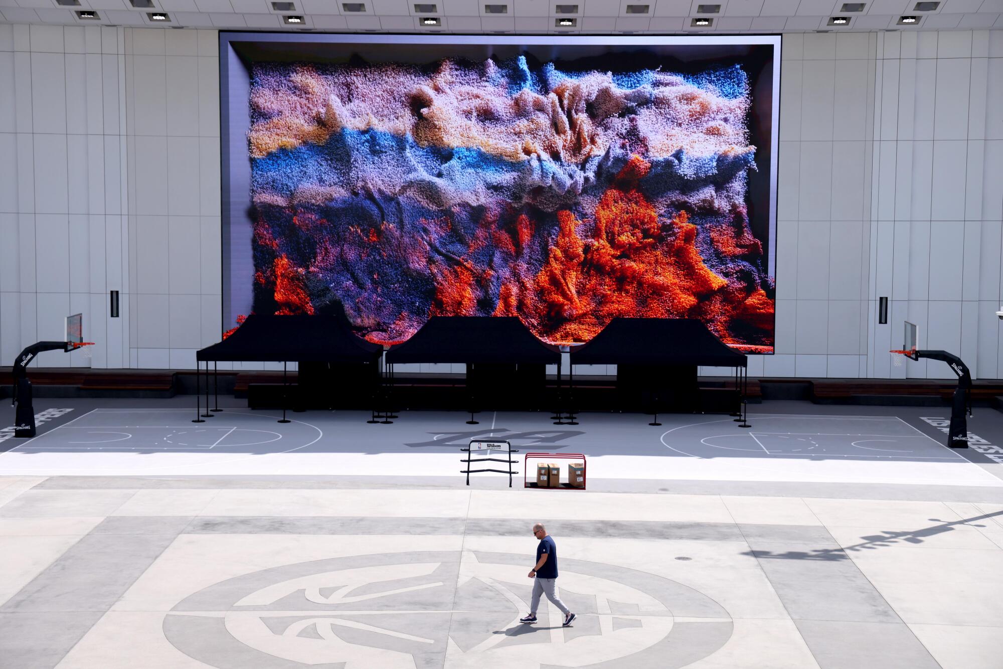 A giant LED screen shows one image created by AI using data from LAX flights, local weather and other sources.