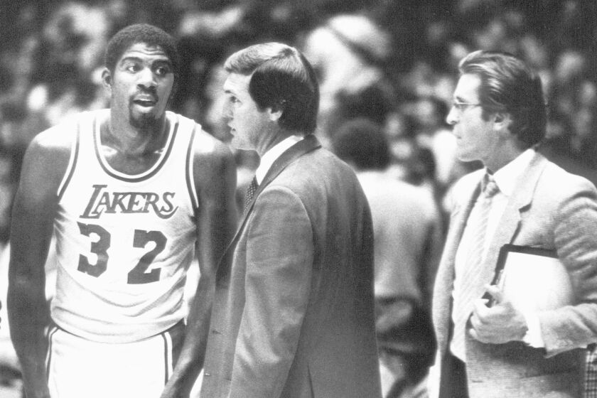 File photo dated 11/20/1981 of Magic Johnson, Jerry West and Pat Riley during 2nd period of game.