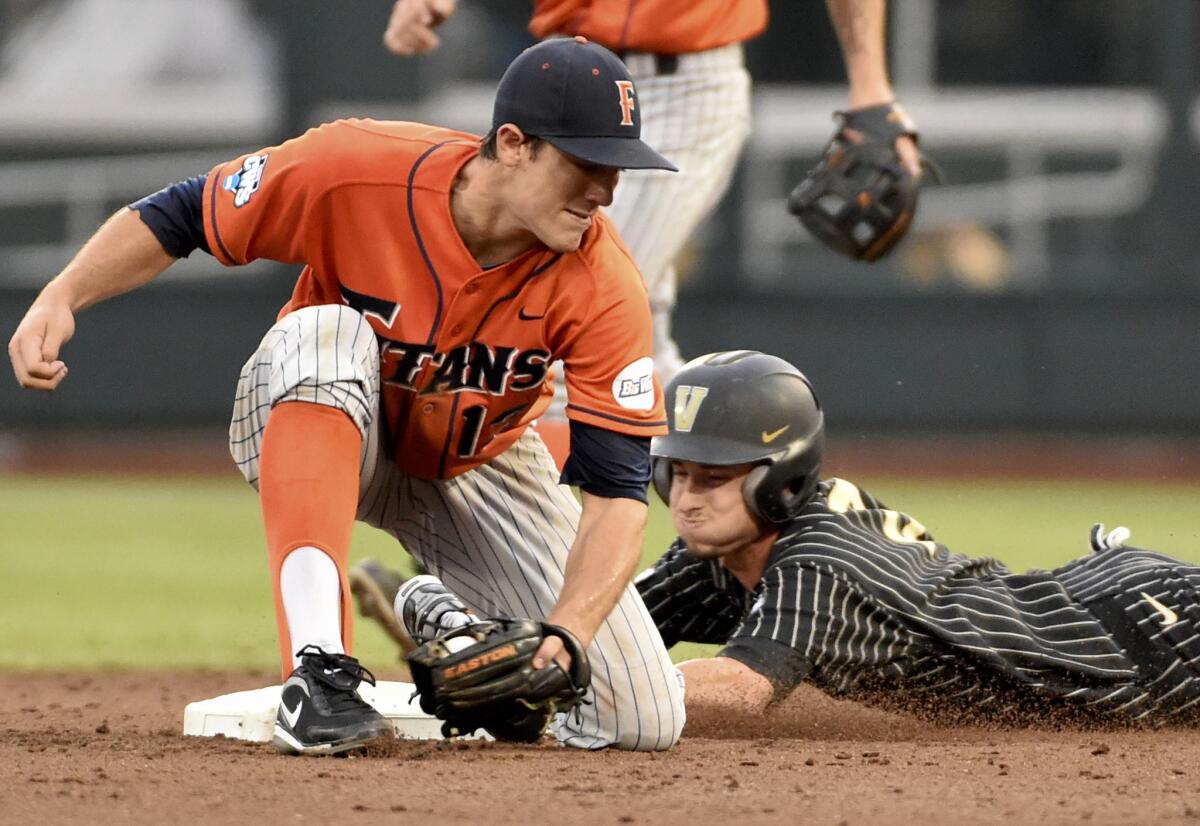 Vanderbilt's Tyler Campbell steals second base against Cal State Fullerton's Timmy Richards during the third inning of a College World Series game Sunday in Omaha, Neb.