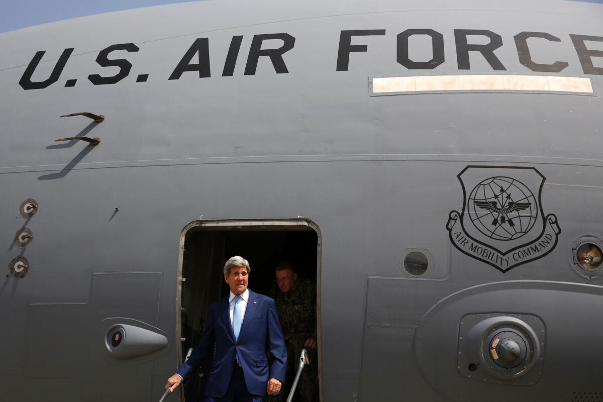 Secretary of State John Kerry arrives via military transport at Baghdad International Airport on Friday.