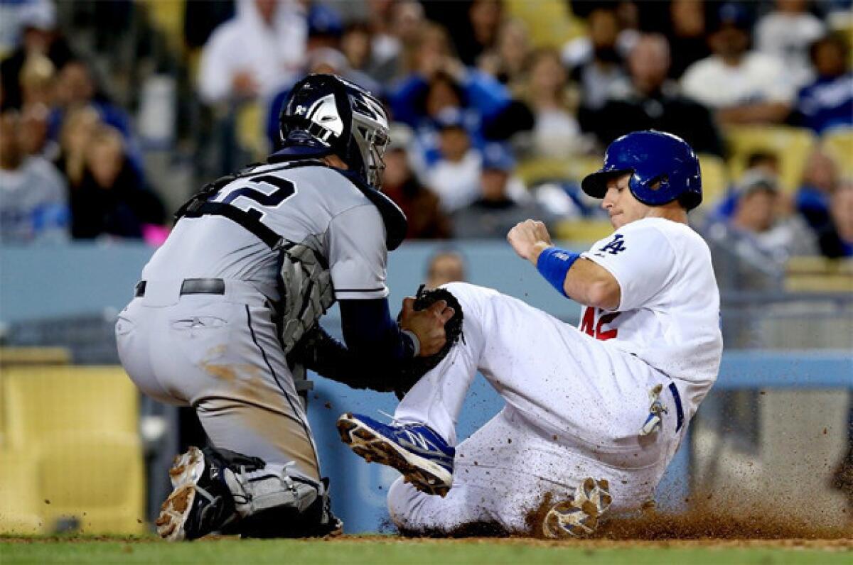 Dodgers catcher A.J. Ellis is thrown out at the plate while trying to score on a groundout.