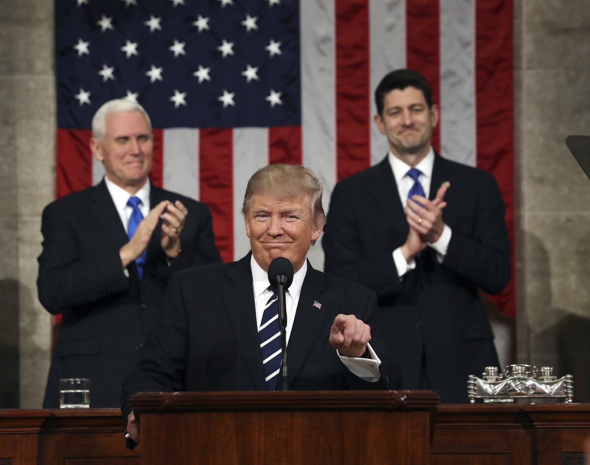 Trump is flanked by Pence and House Speaker Paul D. Ryan of Wisconsin during the president's address to Congress.