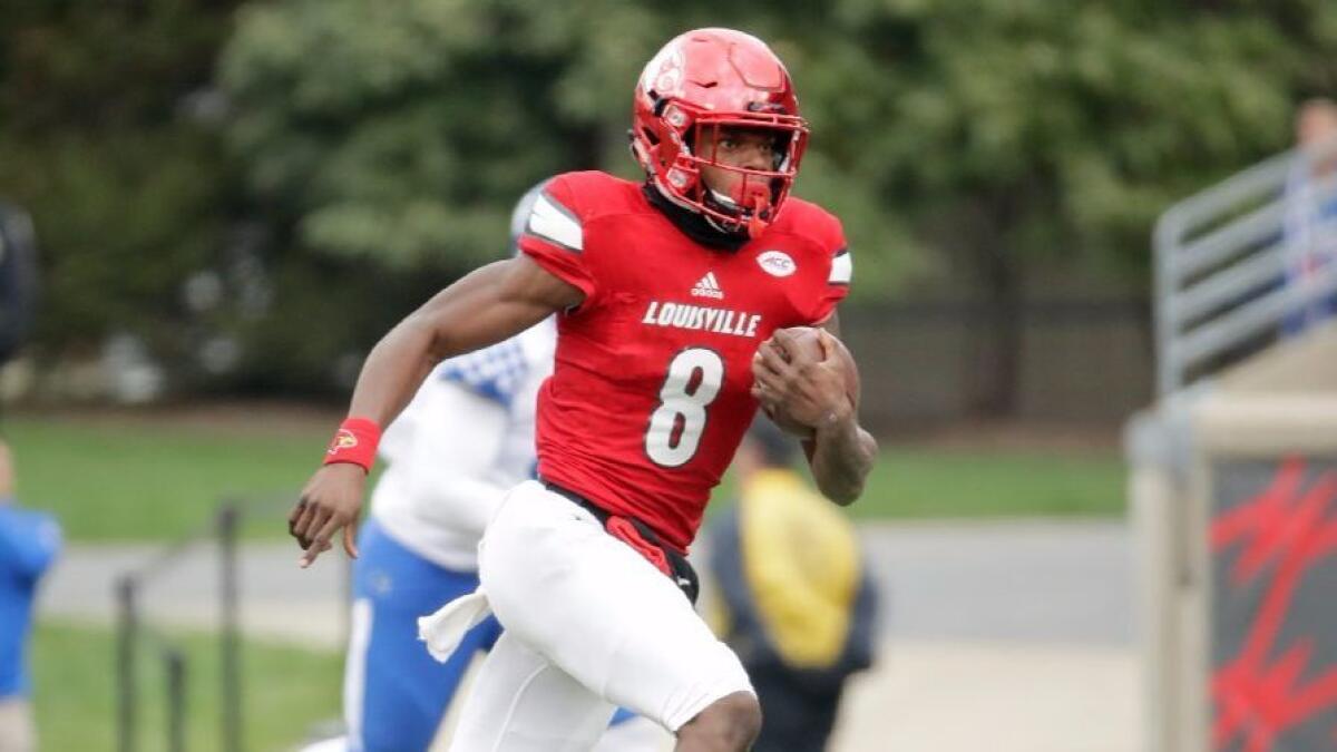 Louisville quarterback Lamar Jackson runs with the ball during a game against Kentucky on Nov. 26.