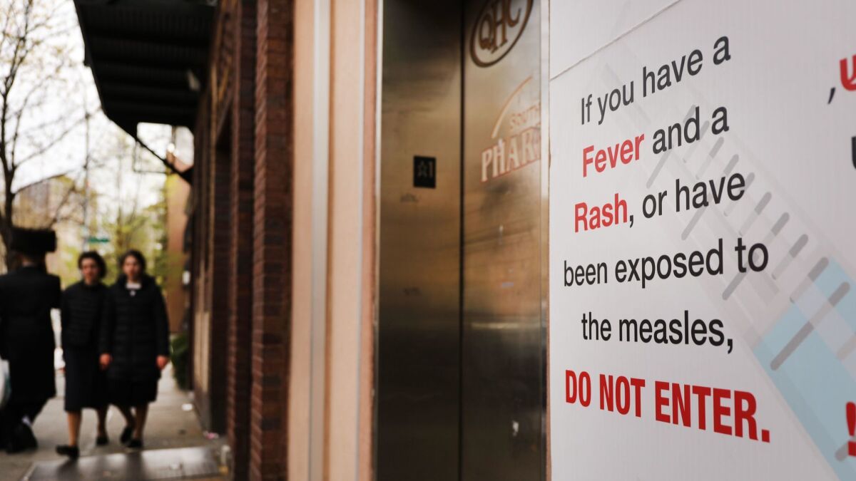 A sign warns people of measles in New York City on April 19.