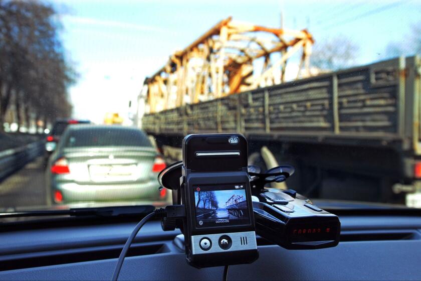 This file photo taken on March 13, 2013, shows a mini camera with a screen placed on a dashboard of a car rolling along a street in Moscow.