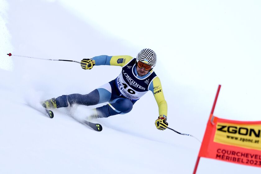 Ukraine's Ivan Kovbasnyuk speeds down the course during the super G portion of an alpine ski, men's World Championship combined race, in Courchevel, France, Tuesday, Feb. 7, 2023. (AP Photo/Gabriele Facciotti)