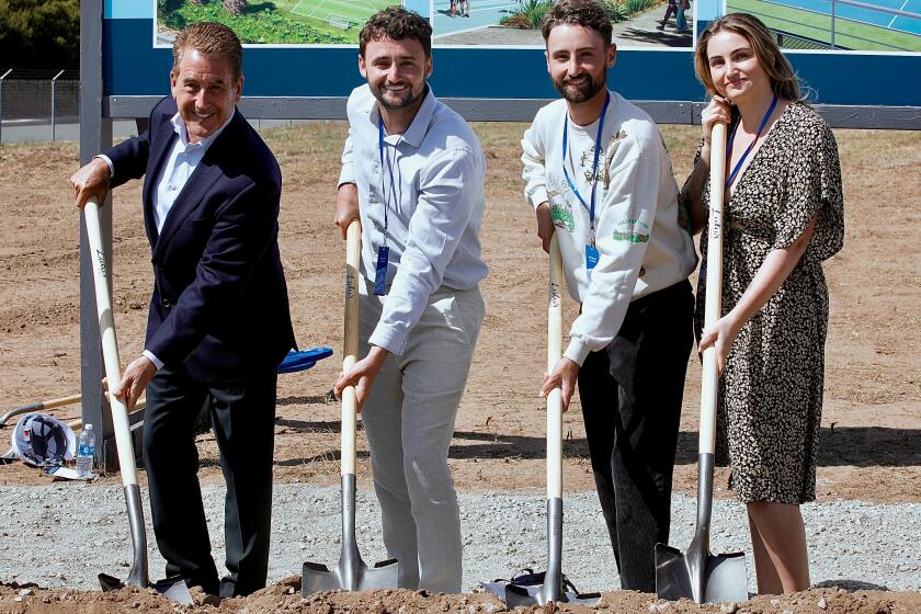 Doug Kimmelman and his children dig their shovels into the dirt at the May 8 groundbreaking.