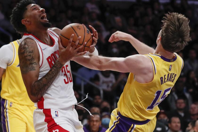 Los Angeles, CA, Tuesday, November 2, 2021 - Houston Rockets center Christian Wood (35) chargers into Los Angeles Lakers guard Austin Reaves (15) during second half action at Staples Center. (Robert Gauthier/Los Angeles Times)